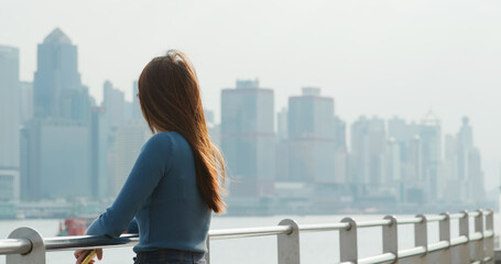 Fototapeta na wymiar Woman looks at the city in Hong Kong
