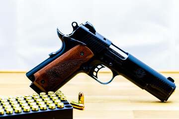 High Angle View Of Handgun With Bullets On Sports Target