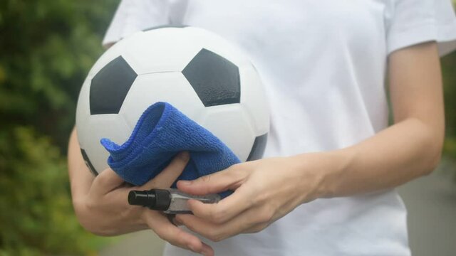 People use alcohol spray cleaning football soccer 