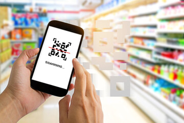 Fototapeta na wymiar Man use smartphone scanning QR code for pay in supermarket.