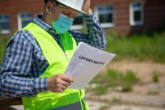 Worker Reads The Layoff Notice Outdoor. Unemployment Concept. Coronavirus Aftermath.