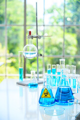 Lab equipment with blue liquid inside stand on the table at laboratory.