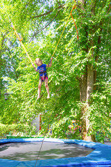 Girl bungee jumping in trampoline