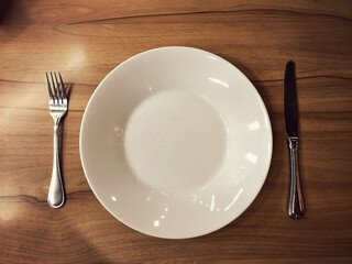 empty eating set dish knife and fork on wooden table photo from above top view