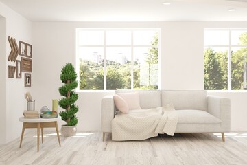 White living room with sofa and summer landscape in window. Scandinavian interior design. 3D illustration
