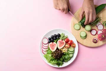 Salad with vegetables and fruit on plate, Vegan food cooking