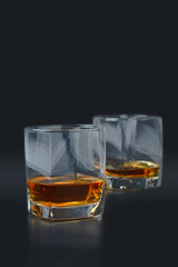 glass of pure scotch whiskey on black background