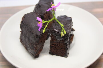 Black forest cake on a white plate.
Delicious black forest created manually.