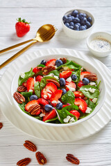 berry spinach salad with nuts and crumbled feta