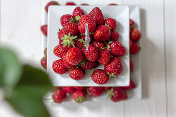 Fresh ripe perfect strawberry. Strawberry on a stand for cupcake on a white background. Strawberry season.