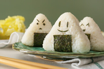 Plate with traditional Japanese onigiri on table, closeup