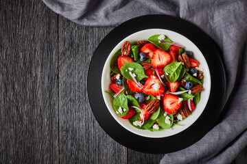 berry spinach salad with nuts and crumbled feta
