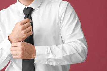 Young businessman in stylish shirt on color background, closeup