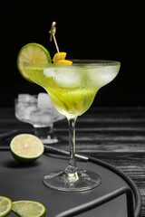 Glass of tasty martini cocktail on table