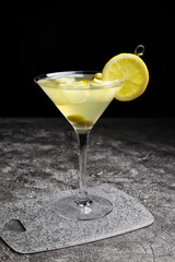 Glass of tasty martini cocktail on table