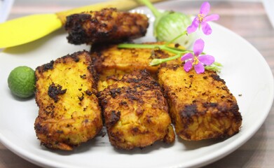 Fried tempe is a typical food from Indonesia.Tempe is made from soybeans.Tempe on a white plate