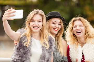 Three women taking selfie outdoor