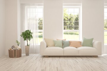 White living room with sofa and summer landscape in window. Scandinavian interior design. 3D illustration
