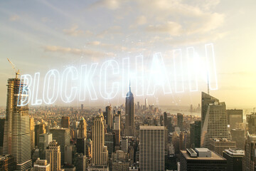 Abstract virtual blockchain technology hologram on New York city skyline background. digital money transfers and decentralization concept. Multiexposure