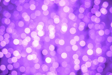 Abstract purple background with bokeh. Blurred backdrop with illuminated effect. Pink night lights, defocused shiny circles.