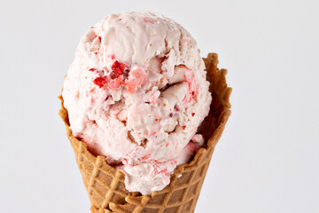 Strawberry ice cream in a waffle cone