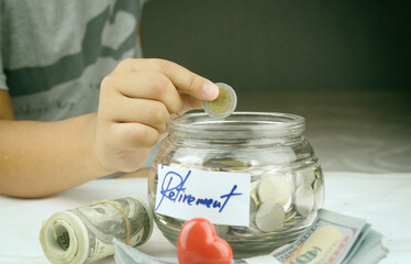 Hand drop money coins to jar. Concept of Insurance money savings for retirement planning .