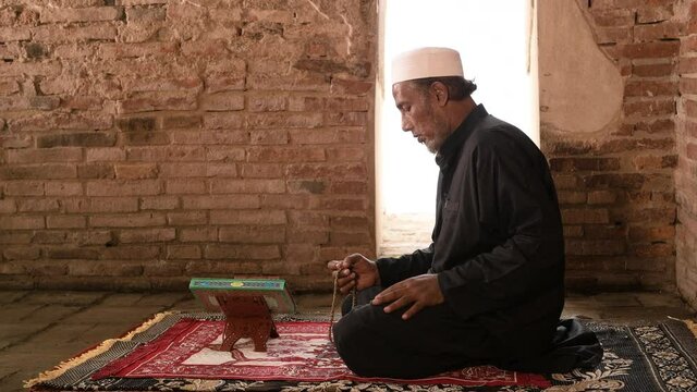 Muslim man praying at an old mosque in Phra Nakhon Si Ayutthaya Province, Thailand, Asian Muslims	