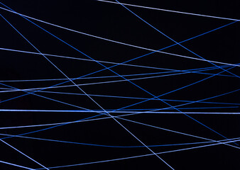 Image of white threads tangled in ultraviolet light