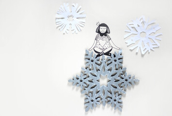 An illustration drawing of a girl sitting on a wooden snowflake