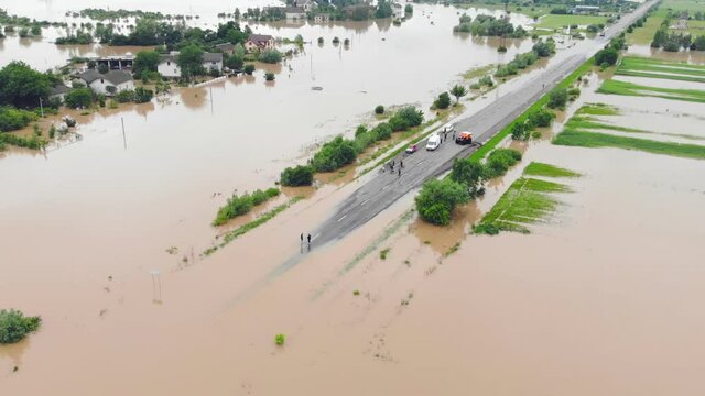 Flooded highway. Flooded road during floods. Cars that can not pass on the road flooded river.