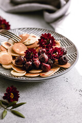 Tiny Pancakes with Cherries on a stone background, selective focus