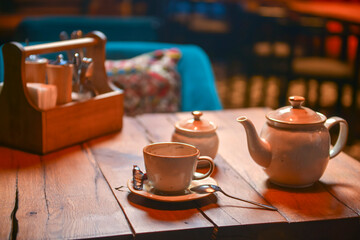 White tea set served on a rustic wooden table in a restaurant. Tea time. Ceramic tea set. Eating out concept.