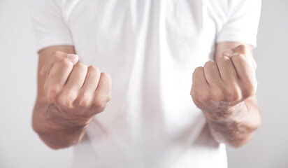 Caucasian angry man threatening with fists.