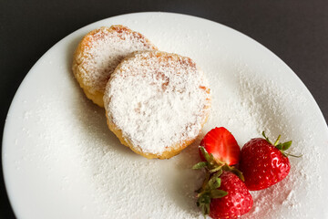 Cottage Cheese Pancakes With Strawberries on dark background