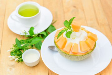 Melon Bingsu with Sweetened Condensed Milk on wood table 