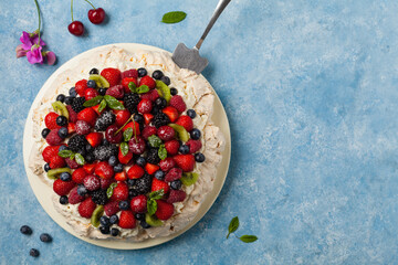 Meringue Pavlova cake with fresh fruit. Top view.
