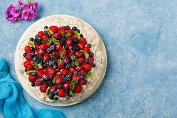 Meringue Pavlova cake with fresh fruit. Top view.