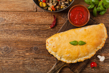 Italian calzone with mushrooms and ham. Top view.