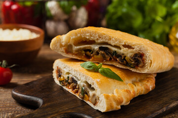 Italian calzone with mushrooms and ham.