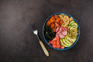 Hawaiian salmon poke bowl with seaweed, avocado, sesame seeds.