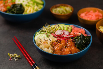 Hawaiian salmon poke bowl with seaweed, avocado, sesame seeds.