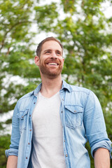 Casual guy with a denim shirt in a park