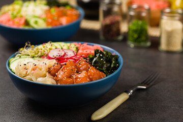 Hawaiian salmon poke bowl with seaweed, avocado, sesame seeds.