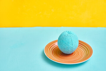 Fototapeta na wymiar painted orange in turquoise color on an ceramic plate. creativity design concept