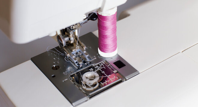 Sewing Machine And Spool Of Tread On White Background