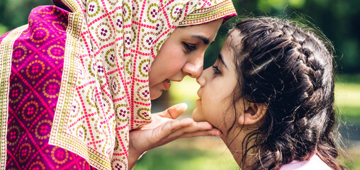 Portrait of religious enjoy happy love asian family arabic muslim mother and little muslim girls...