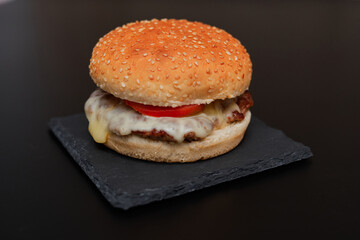 cheese burger on top of a black board