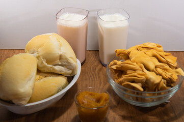 Fresh French bread with milk and crustoli on white background.
