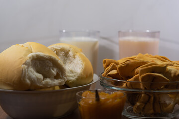 Fresh French bread with milk and crustoli on white background.