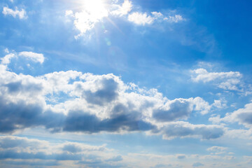 beautiful blue sky background with cumulus and cirrus clouds at a bright sunny day